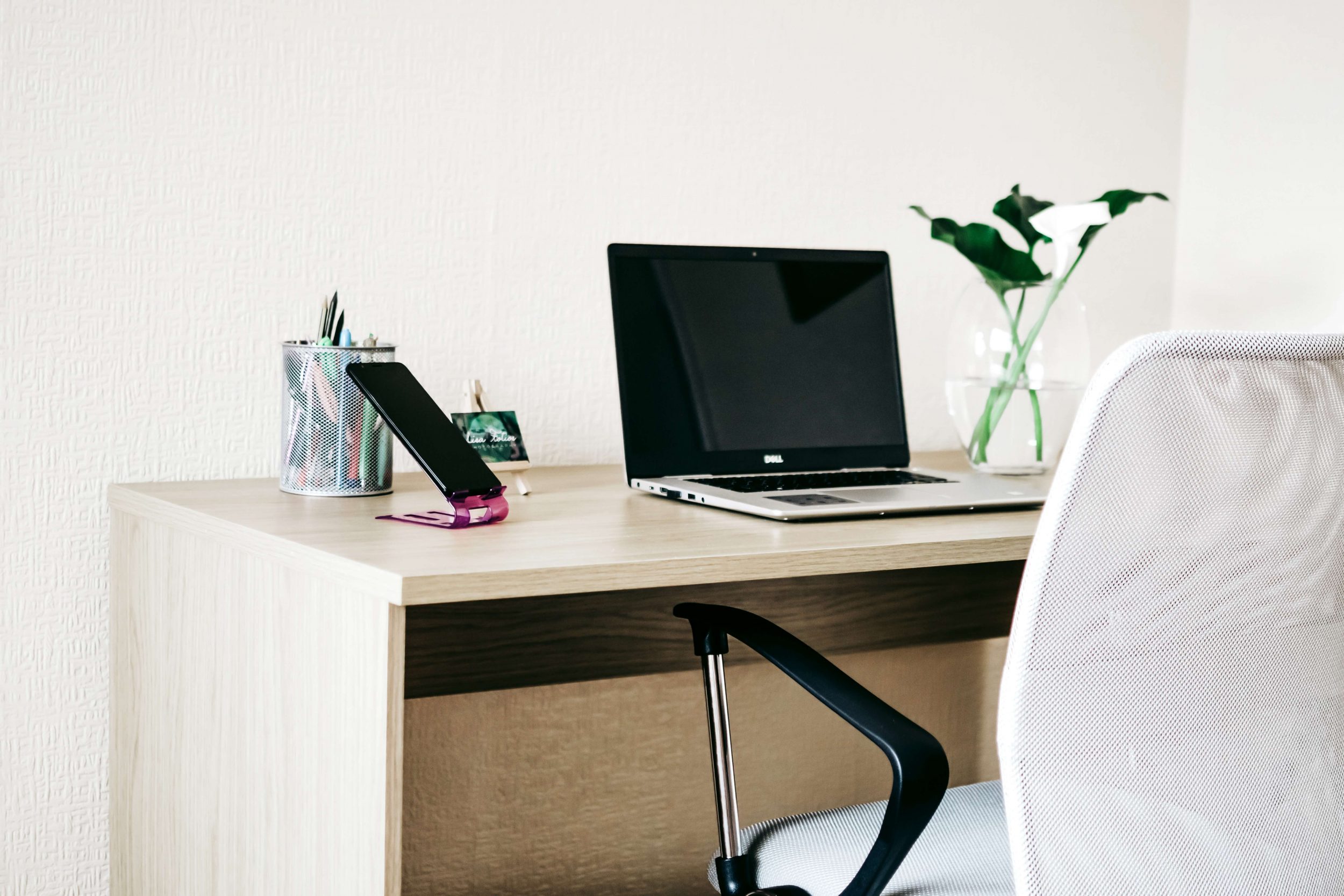 Laptop on brown desk, home work station.