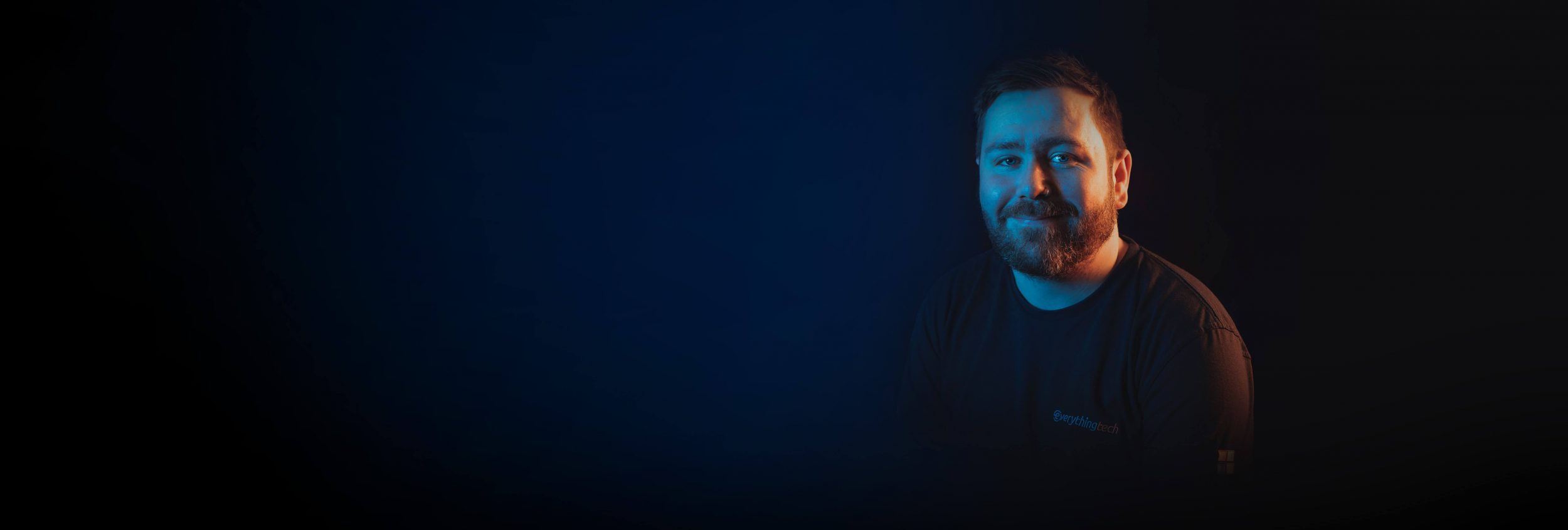 everything tech staff member right side blue gradient background for header