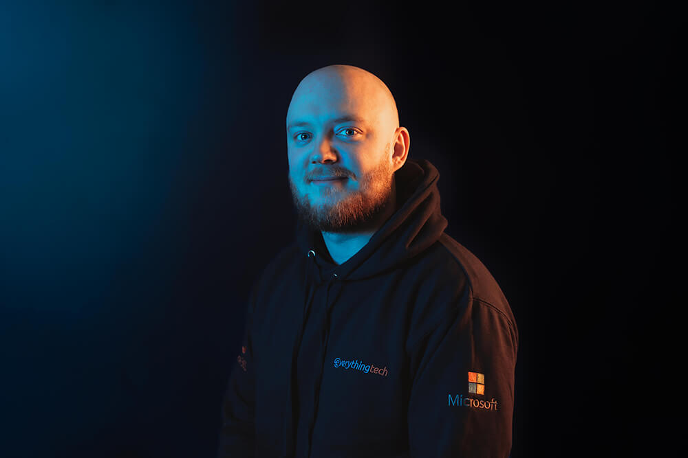 everything tech leadership staff member portrait with blue gradient background
