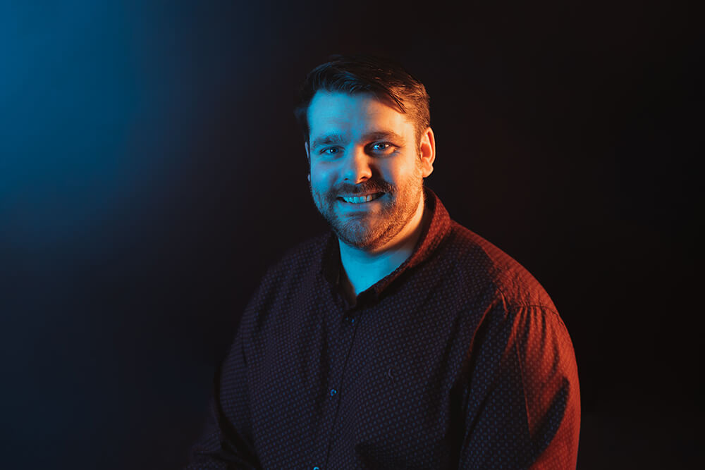 everything tech leadership staff member portrait with blue gradient background