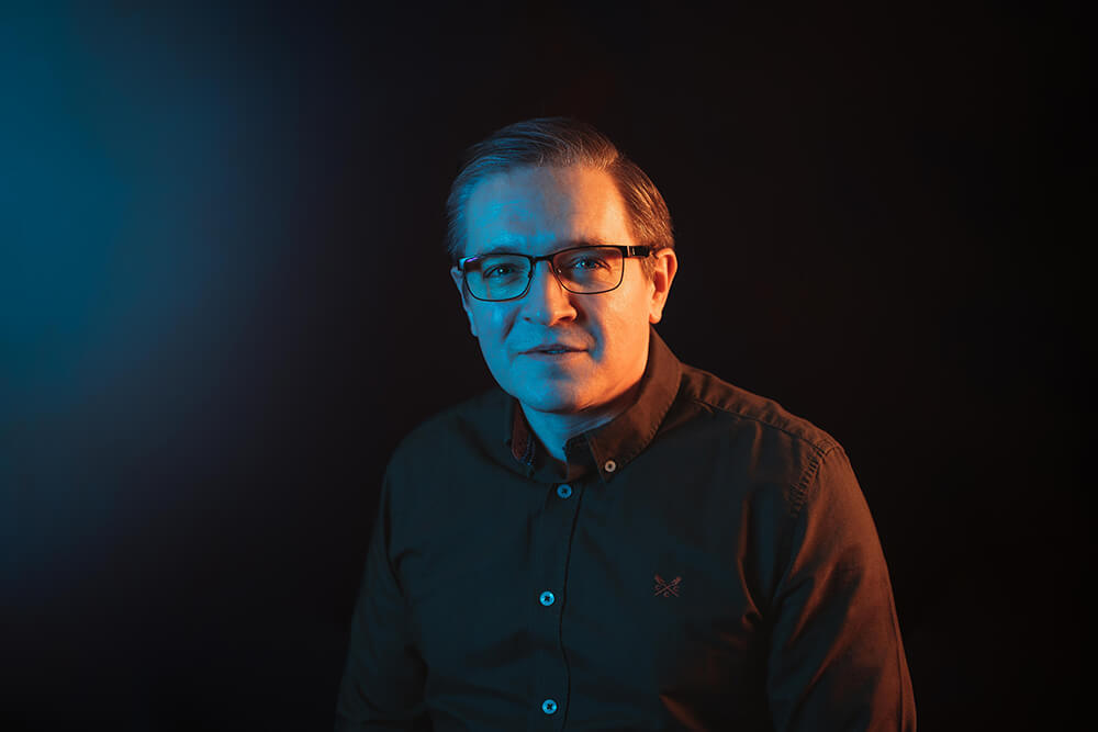 everything tech leadership staff member portrait with blue gradient background