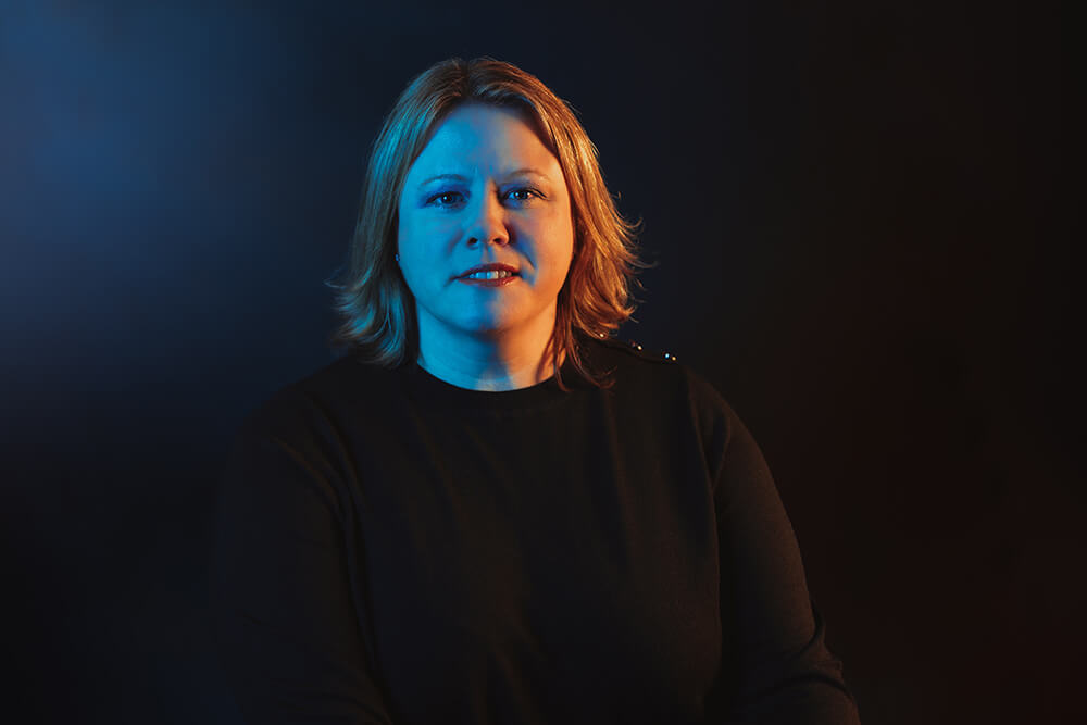 everything tech leadership staff member portrait with blue gradient background