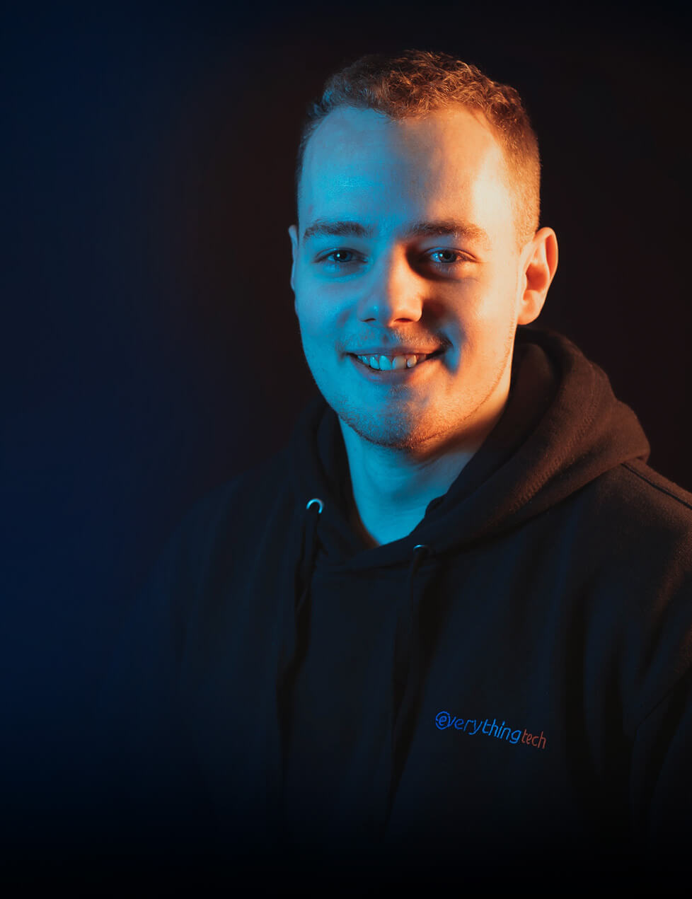 everything tech staff member portrait with blue gradient background for mobile