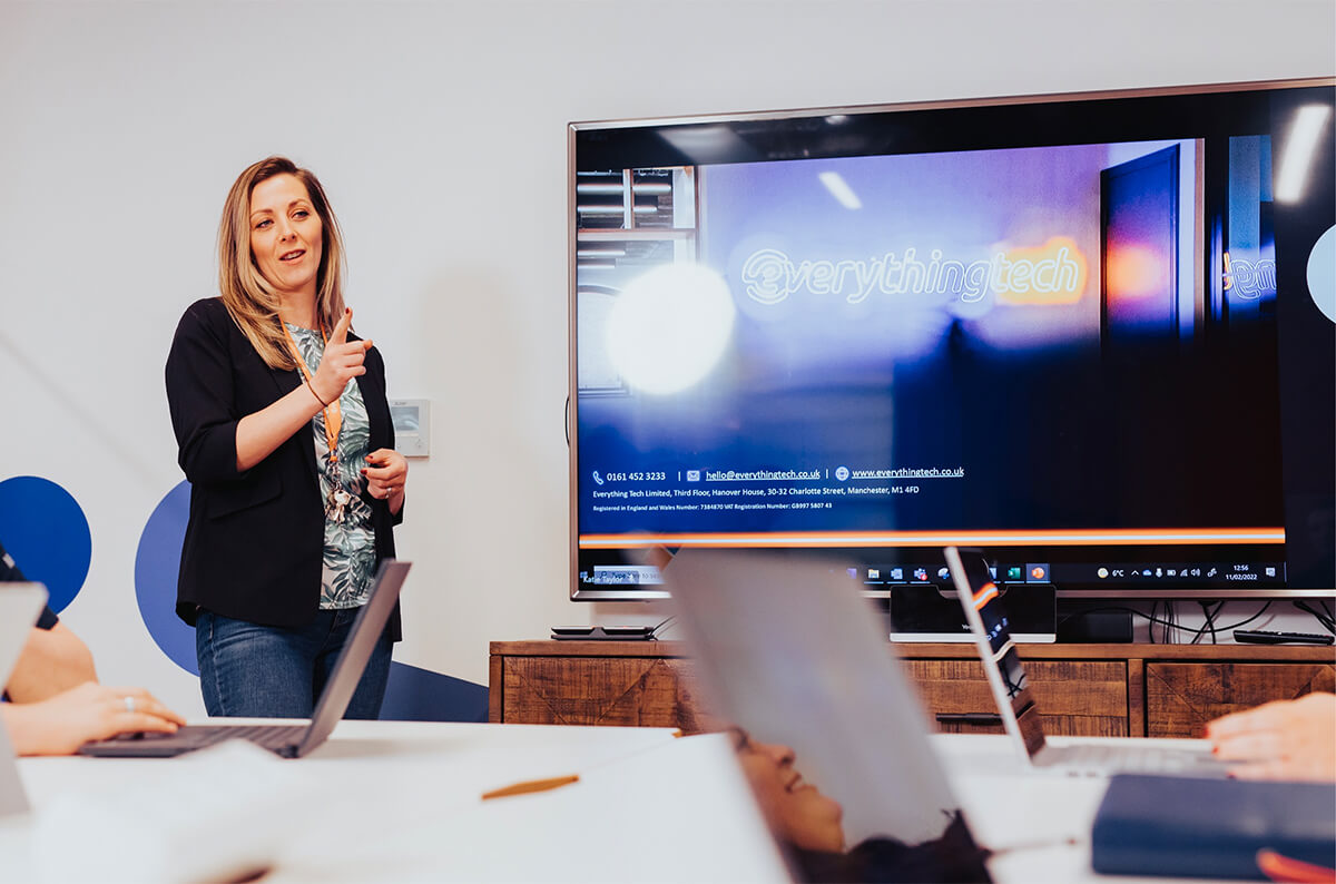 everything tech careers page hero image - staff member during meeting